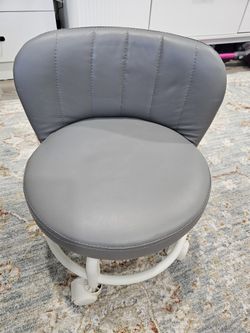 New, cushioned low stool/seat with wheels. 