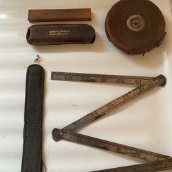 Antique Measuring Tapes and Sharpening Stone 