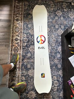 Evol Snowboard with Peace Sign Graphic
