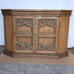 Cabinet With Gate Doors that open to 2 Shelves Inside Storage Space.