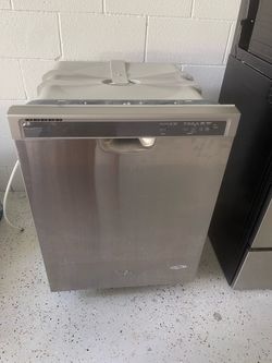 Set of Whirlpool stainless steel kitchen appliances, including a stove, microwave, and dishwasher. All items are used, but in good working condition.