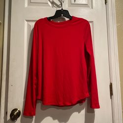 Red long sleeve top with a relaxed fit