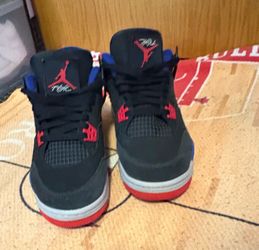 Nike Air Jordan 4 Retro 'Rare Air' sneakers featuring a black nubuck upper with vibrant red and blue accents Jordan’s 7 Youth