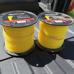 Two Spores Of Trim Wire For Trimming Around Houses Or Industrial Parks