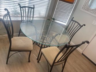 Round glass dining table with chairs