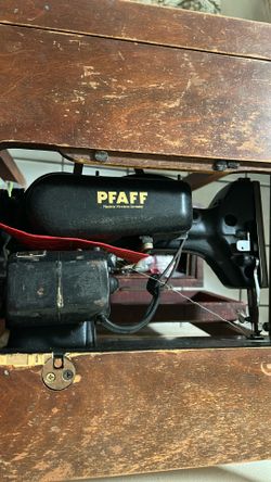 Antique sewing machine with cabinet