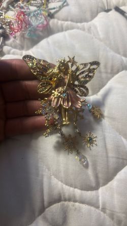 This vintage Kirk's Folly brooch features a gold-tone fairy with enameled pink wings