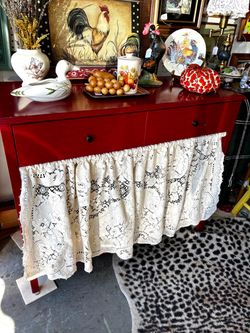 Red buffet cabinet with lace skirt, drawer inside storage with shelving, cottagecore country style