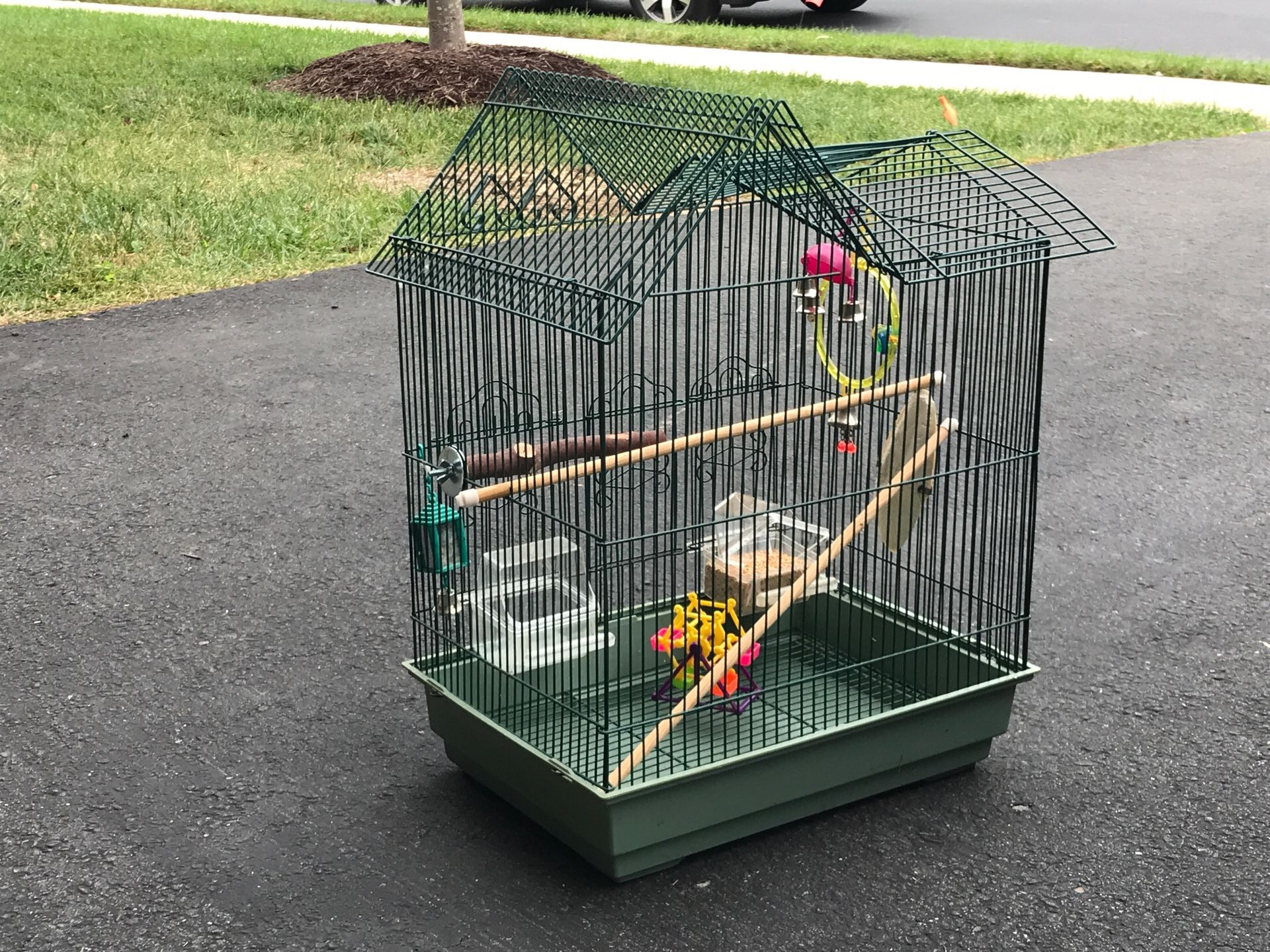 Parakeet cage, includes feeder dishes and all accessories.