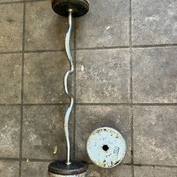 Selling Rugged Iron Curling Bar With 80 Pounds Of Weights 