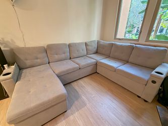 Grey C-Shaped Sectional Sofa with Storage, Charging Ports & Sleeper Bed (negotiable price)