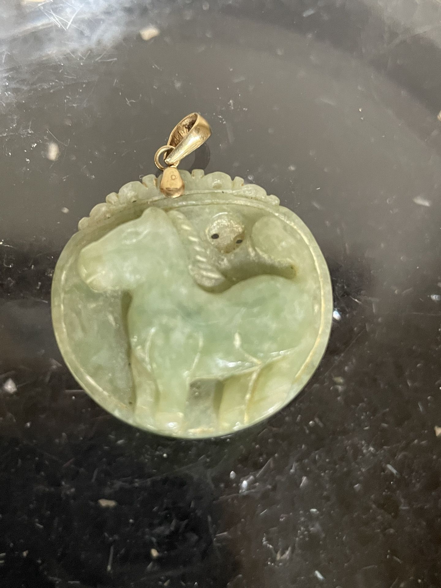 Carved Green Jade Carved Horse Pendant with a Gold Bail . 1.25” D