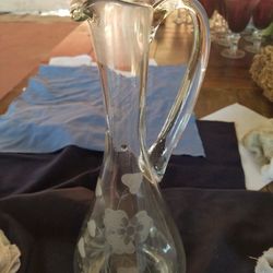 Tall handled wine carafe/ flower vase with flower and heart shaped leaf design . 13 1/2 inches tall A55V914