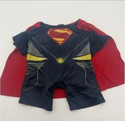 Build-A-Bear Workshop Superman "Man of Steel" plush costume featuring a one-piece navy blue suit with a red cape.