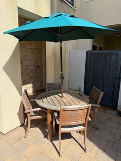Outdoor table chairs and parasol