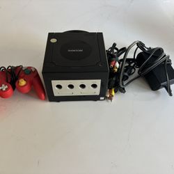 Black Nintendo GameCube with controller, and adapter