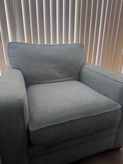 Two matching light gray arm chairs