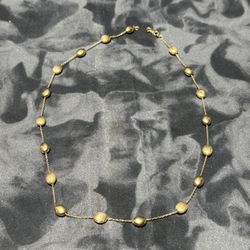 14kt Yellow Gold Pebble Station Necklace  The 14kt Yellow Gold Pebble Station Necklace is a stylish and elegant piece of fine jewelry. Crafted from 14