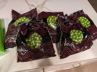 Paintballs with holding canisters