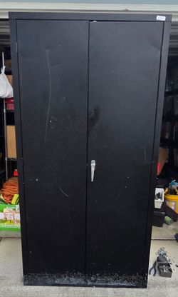 Durable metal storage cabinet is black with a double-door design. This unit has four adjustable interior shelves and a locking handle mechanism. The e