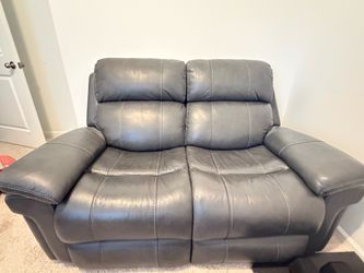 Rooms to go couch and love seat set in dark grey