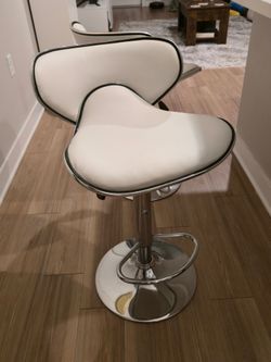 Height bar stools with back and footrest.