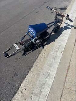 Selling mini bike navy blue and navy blue seat with stickers and wheelie bar and running engine