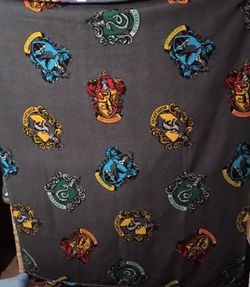 Harry Potter House Crest Fleece Featuring Gryffindor, Slytherin, Ravenclaw, and Hufflepuff on Gray Background