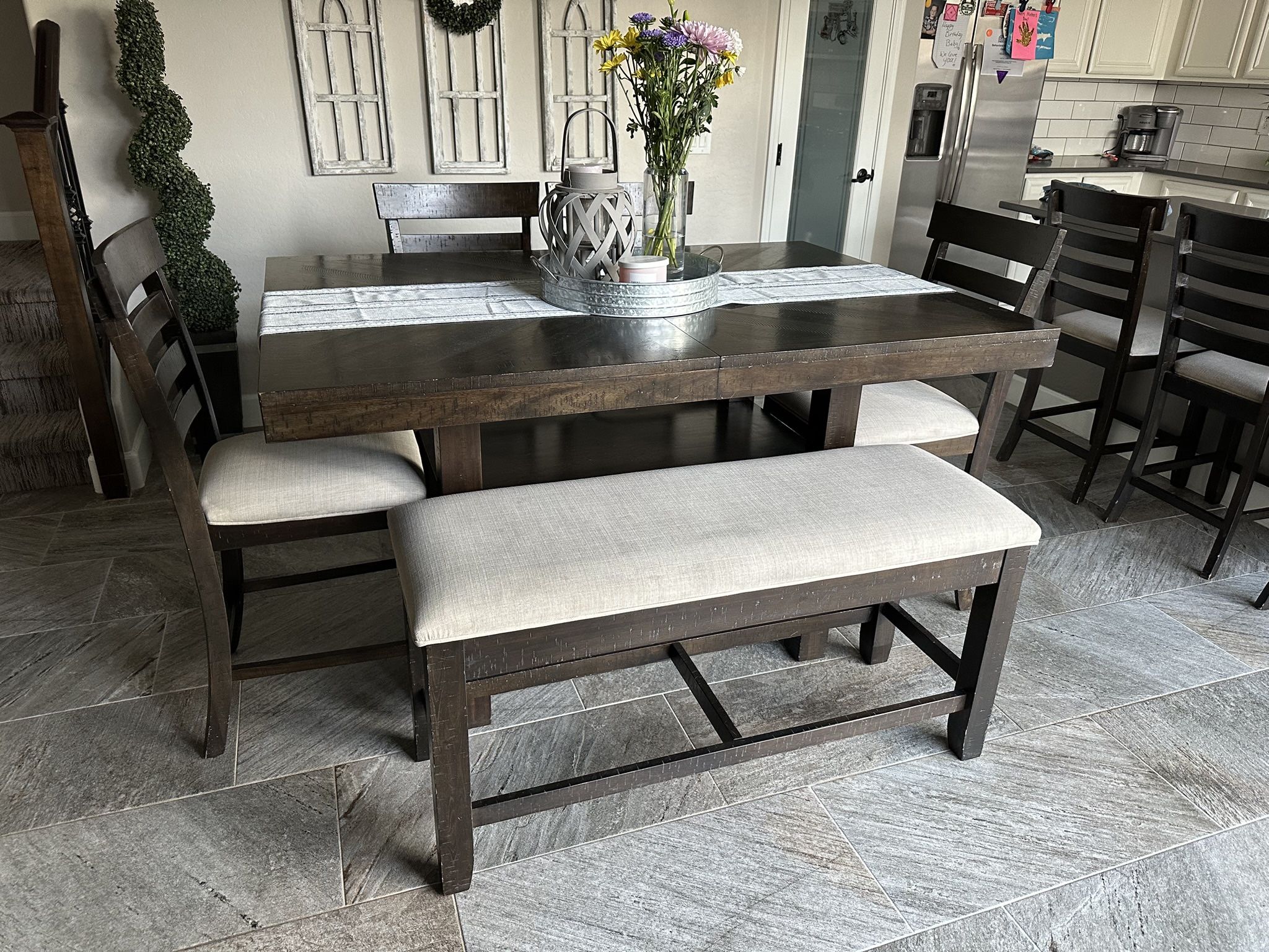 Gorgeous counter height, dinette set, four counter height, chairs, and one bench that opens to storage. Plenty of storage under the table as well.