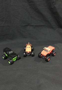 3 Plastic Monster Trucks