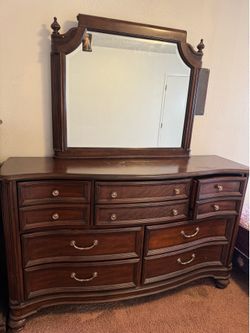 Queen bed and a dresser with mirror.