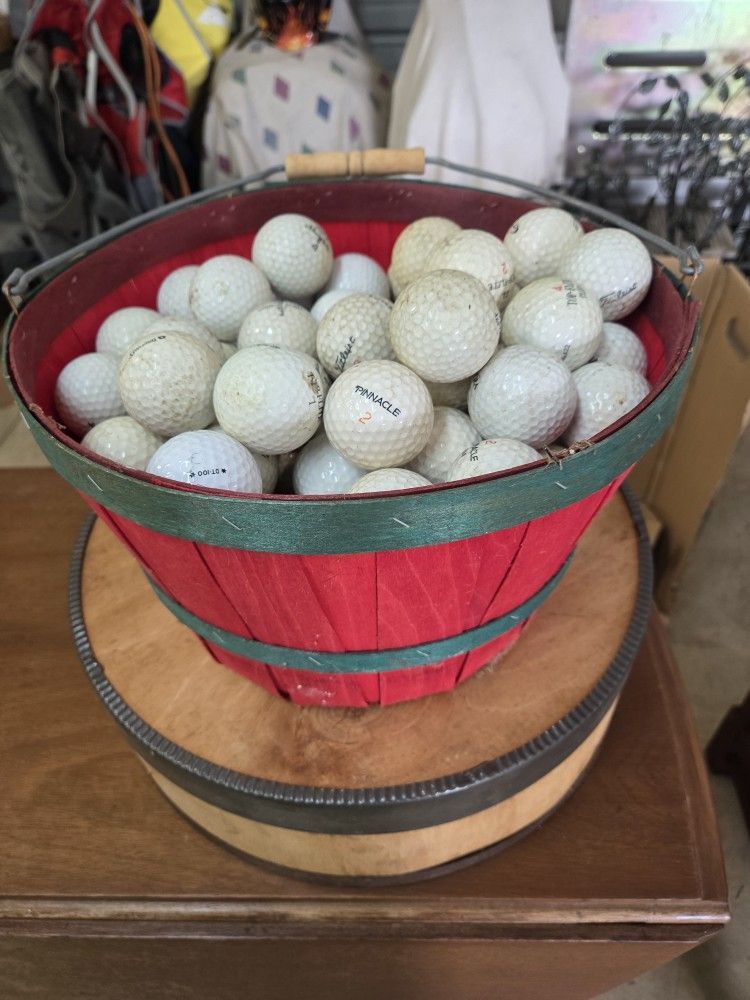 basket full of used golf balls
