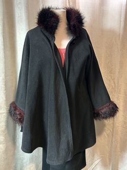vintage Dillard's black fleece cape featuring a contrasting burgundy or deep red faux fur trim along the collar and wide cuffs