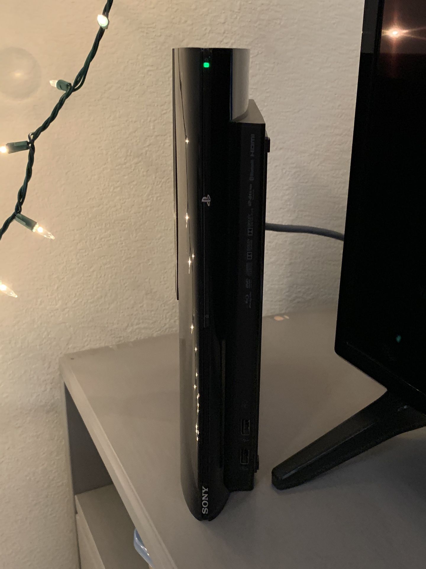 PS3 Slim, 2 controllers, charging stand, 9 games