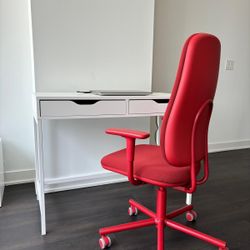 white desk and red office chair with armrests