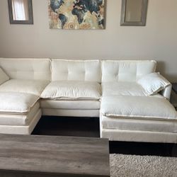 Beige U Shaped Section With Two Ottomans 