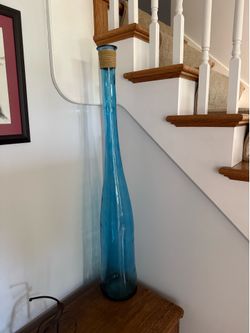 Tall blue glass decorative bottle