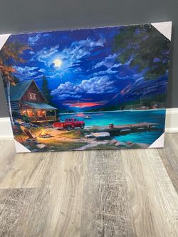 Brand new 18 x 24” wood backed canvas wall art of lake house at night time