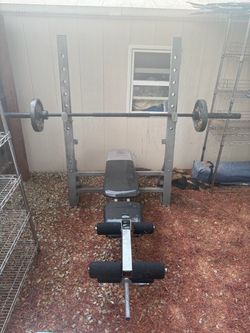 Gold gym Bench press with olympic bar and 2 25 plates