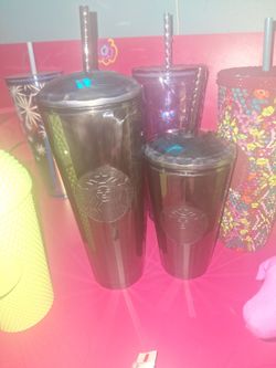 Two black matching Starbucks cups
