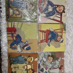 T.J. Whitneys’ Traditional Toys - Raggedy Ann & Andy Raggedy Ann & Andy  Board Wall Hanging with Ribbon. Sealed. Set Of 7 Pieces