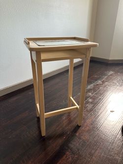 Side table with glass top and small shelf