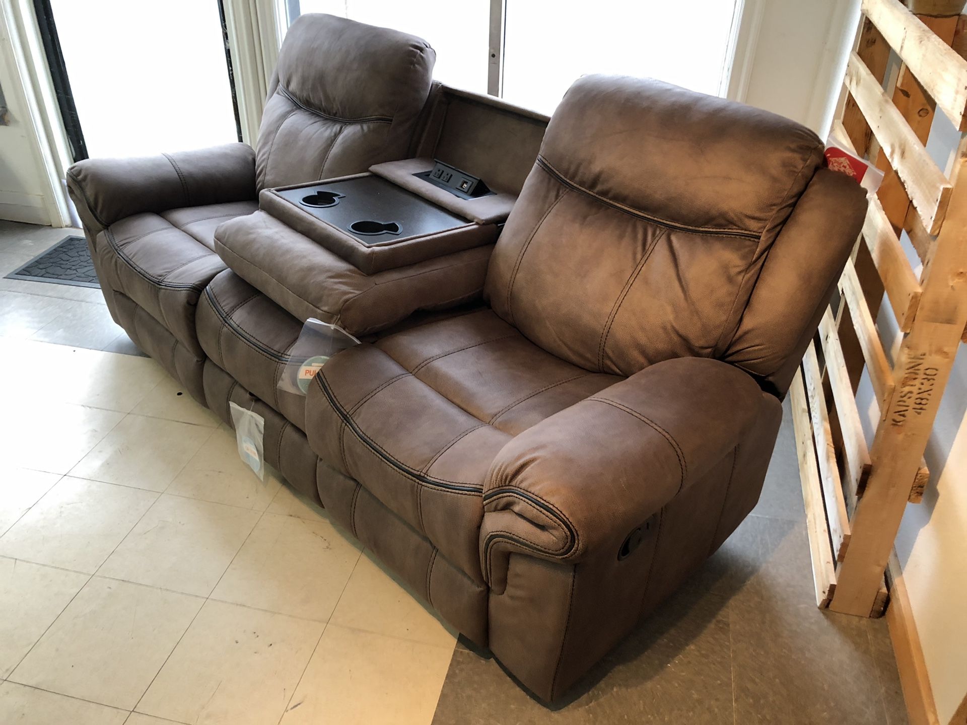 WATER RESISTANT Microfiber smooth bomber jacket material recliner. Pull out table with cup holders. Built in USB ports and wall plug ins. Hidden draw