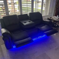 Electric reclining sectional sofa with LED and speakers.