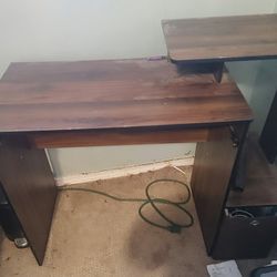 Brown Ikea desk with monitor stand and some storwge