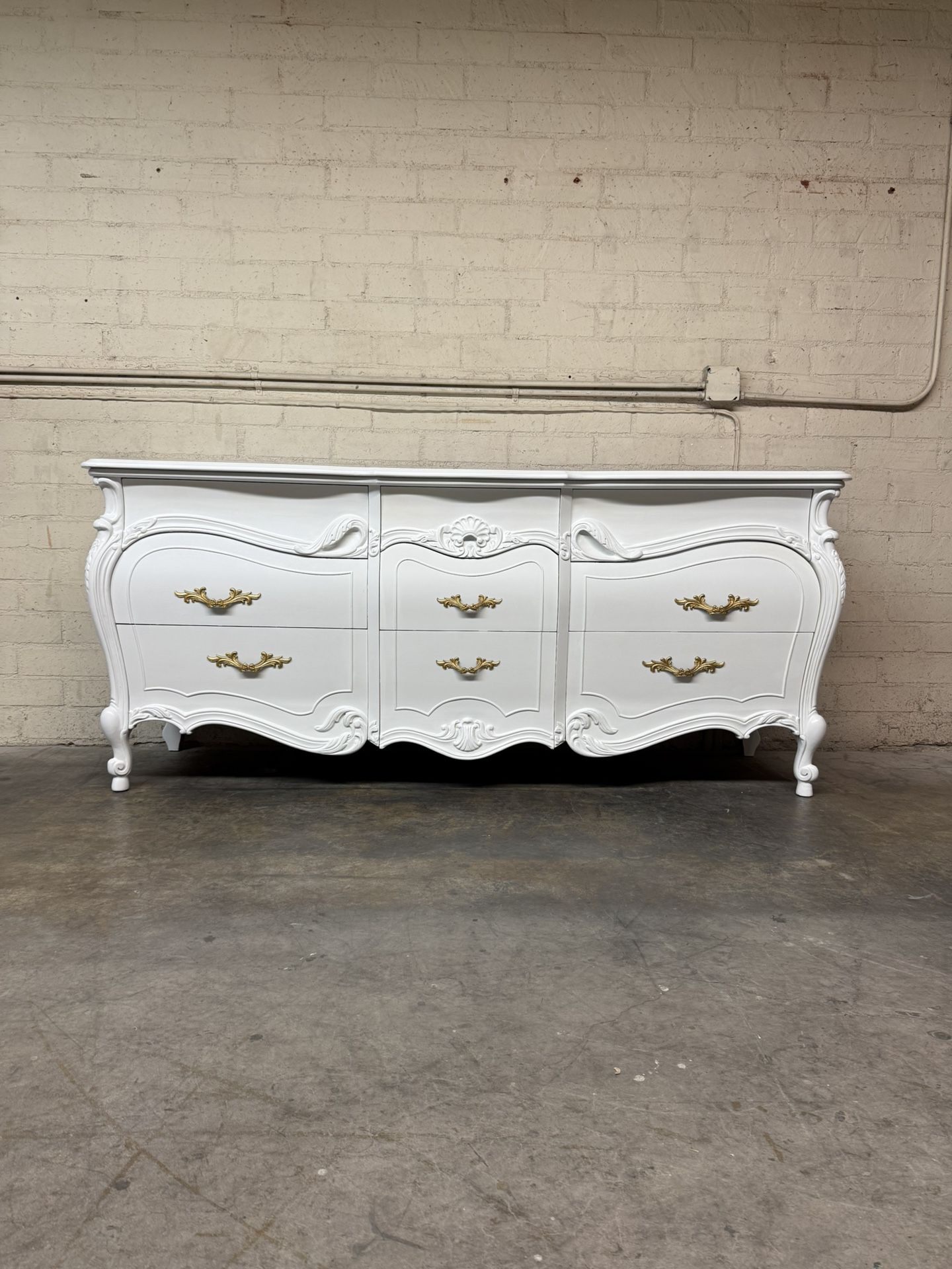 Delivery Is Available Vintage French Provincial style dresser with ornate gold hardware and carved details, painted in white$1350 Obo!