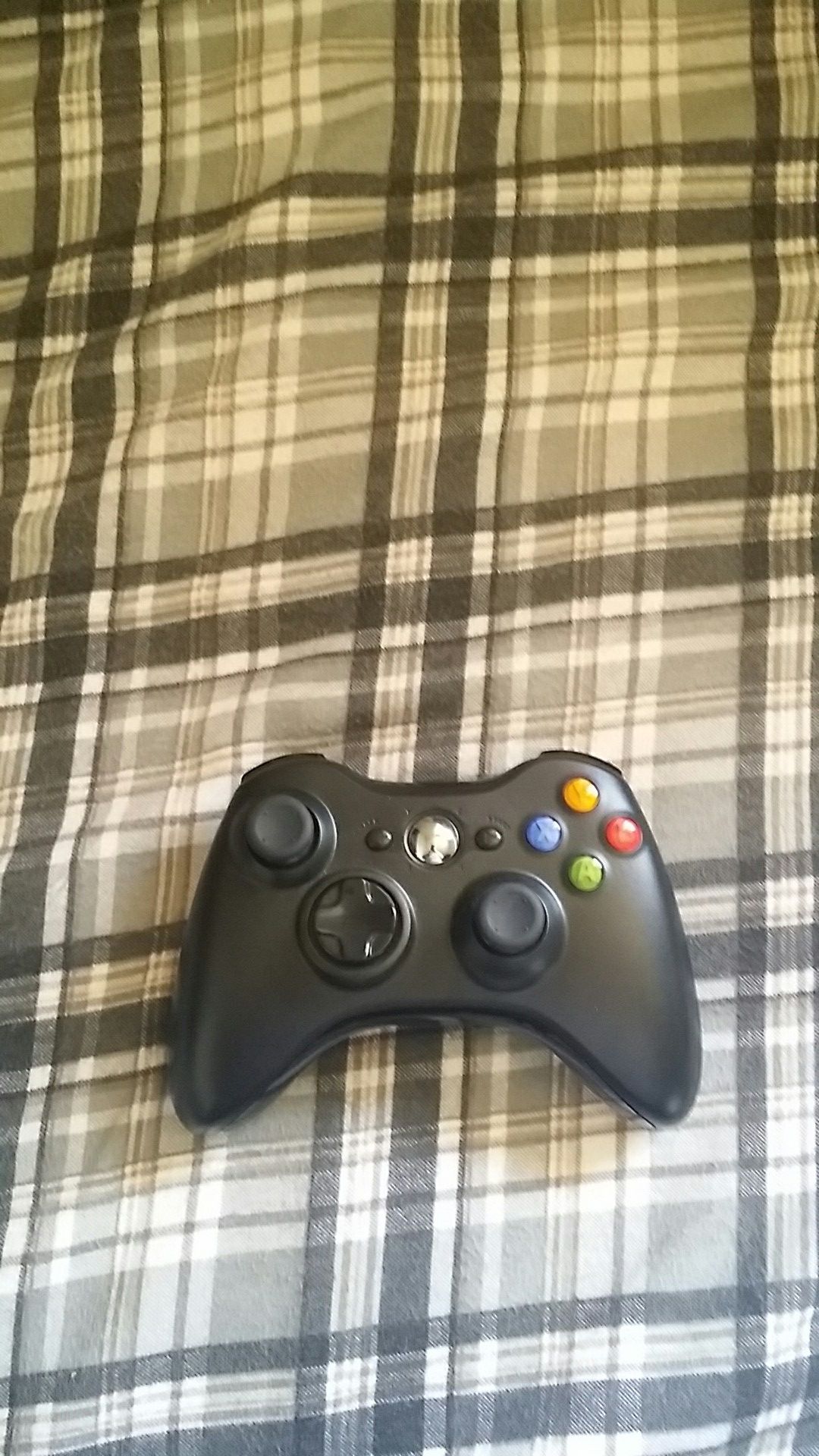 A well kept xbox controller with a 2.4g wirless gaming receiver and a pack of Duracell.