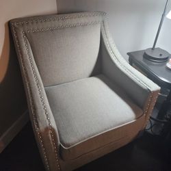 Stylish gray armchair with nailhead trim