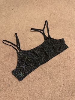 Comfortable black crop top with subtle multicolor light reflective geometric print details. Soft, stretchy fabric and an easy fit. Adjustable straps l