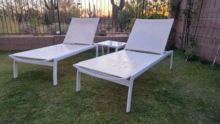 Two Frontgate chaise lounge chairs and a side table